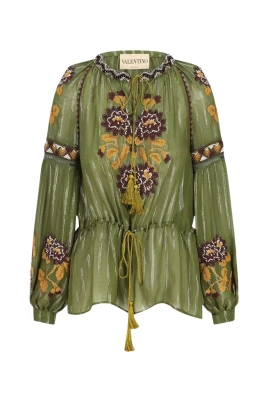 Broderad genomskinlig blus med tofsar