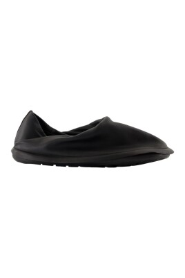 black-leather-sneakers-with-brass-details