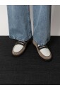 white-flat-shoes-with-iconic-detail
