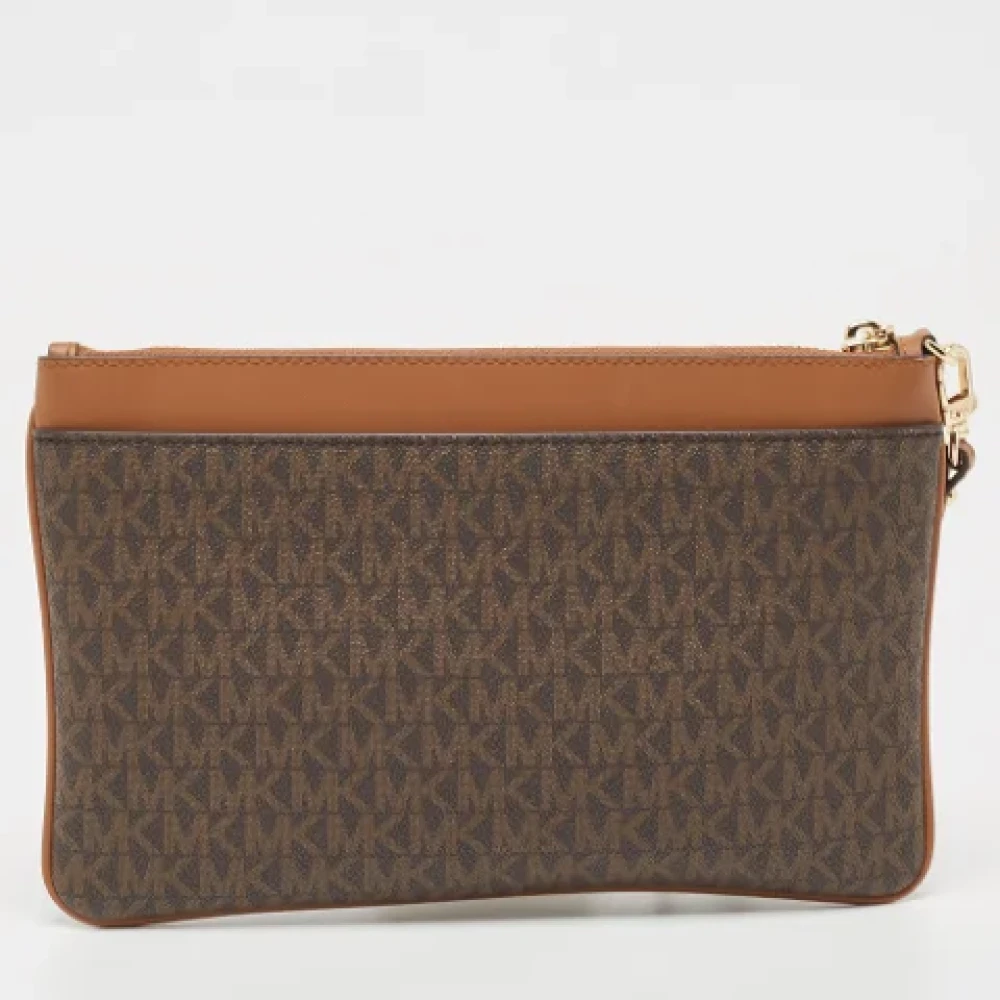 Michael Kors Pre-owned Canvas clutches Brown Dames