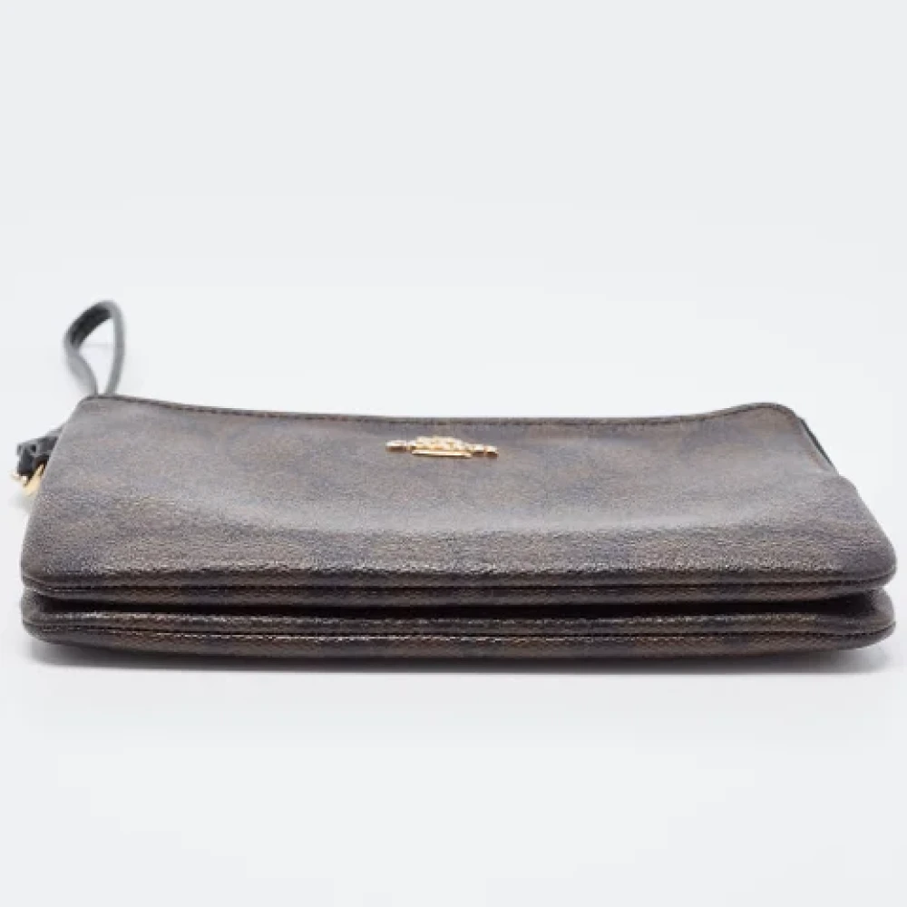 Coach Pre-owned Coated canvas clutches Brown Dames